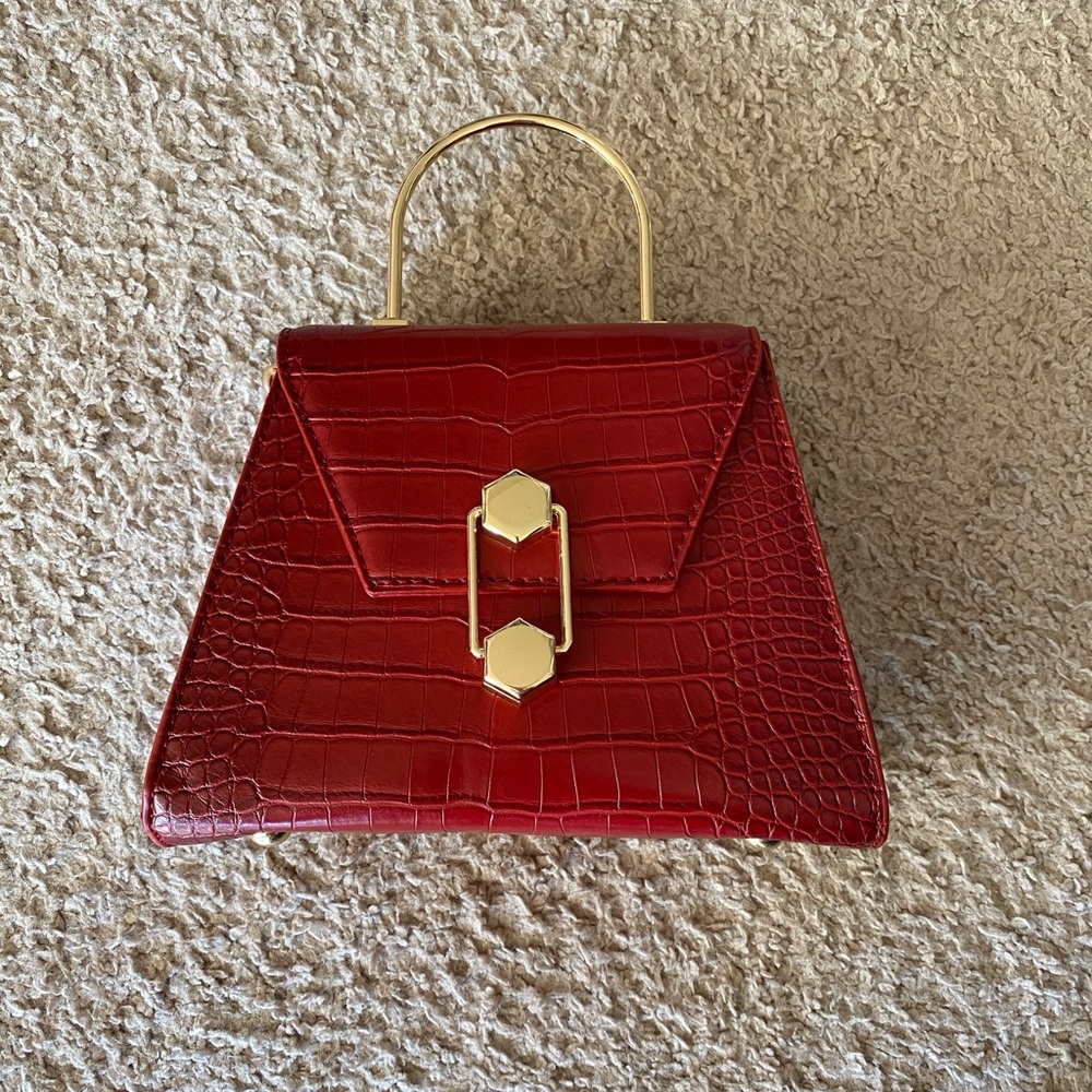 Red purse with golden chain and lock